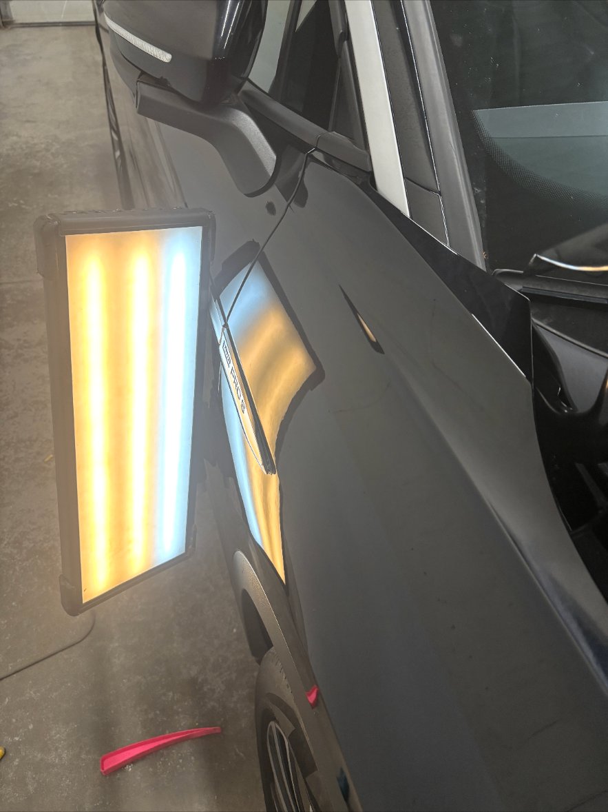 Rear door — black SUV after repair
